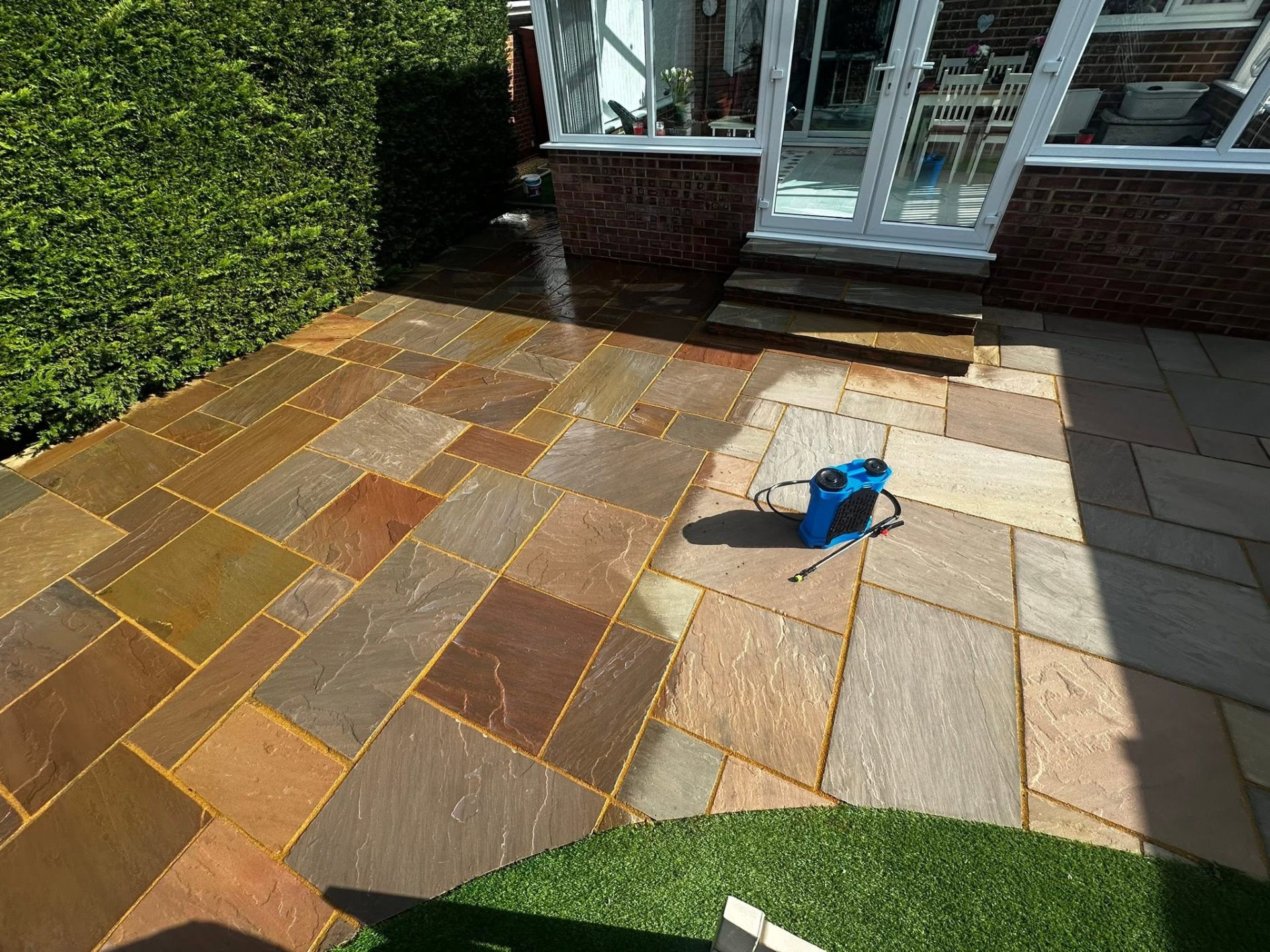 Rippon buff sandstone patio after professional patio cleaning, Dorset