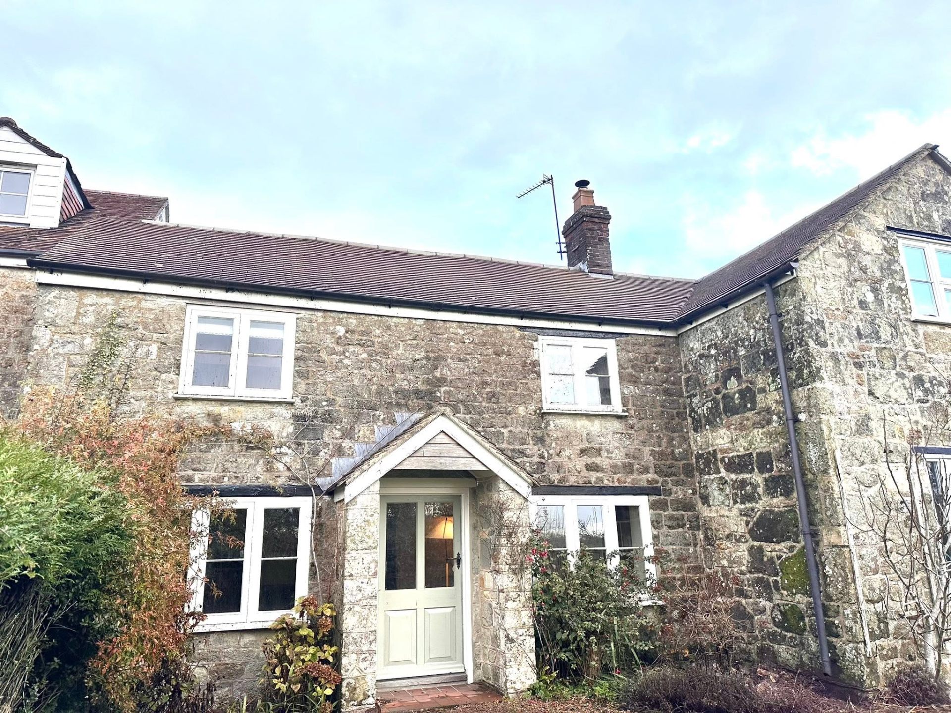 Traditional Dorset stone cottage roof after professional softwash cleaning