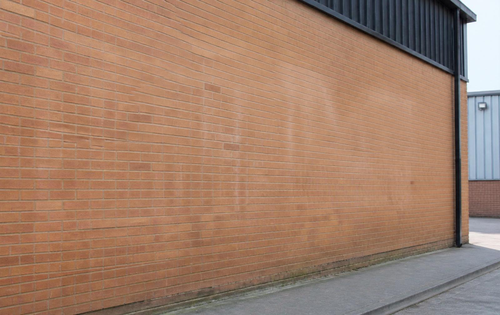 Commercial brick wall after graffiti removal